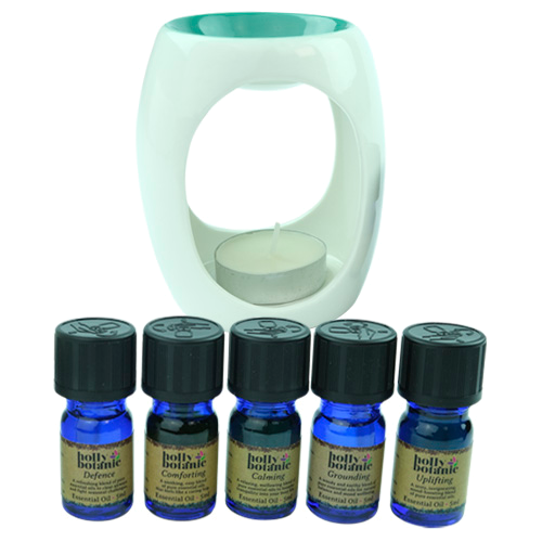 5ml bottles of the six Holly Botanic essential oil blends; calming, comforting, defence, festive, grounding and uplifting, with an oil burner and tealight candle. 