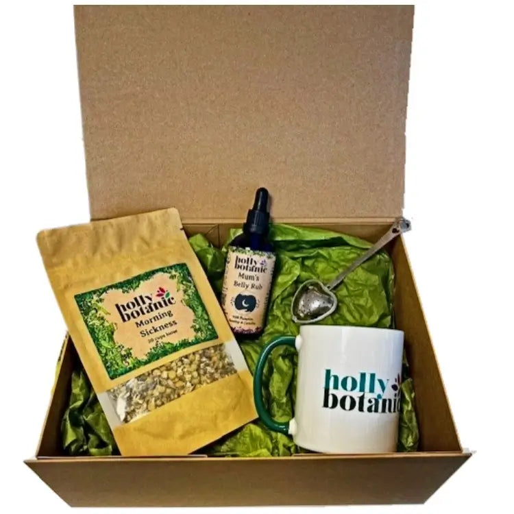 a handmade gift set containing breastfeeding tisane, belly rub, mug and infuser designed for pregnant mums to be. Presented in a magnetic-close, cardboard box.